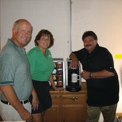 Tom and Renee Ridenour of Pine Mountain Springs, left, talk with Kraft technician Larry Tiernan about the Tassimo brewer, a popular option for high end office coffee clients that want specialty coffee drinks.