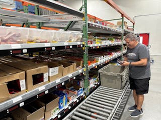 Quality Vending&apos;s Al Christofano pulling snacks in the warehouse.