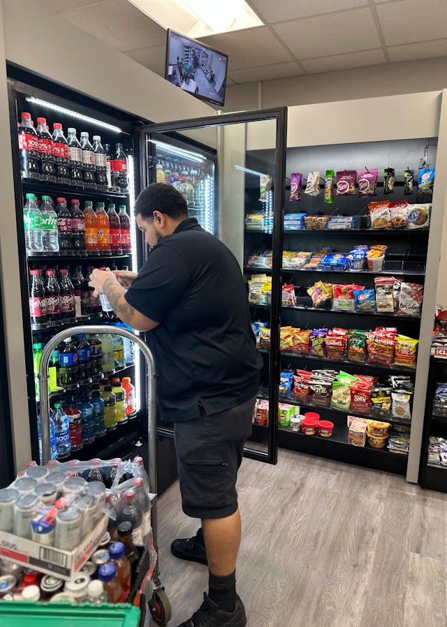 Delivery driver Isiah restocks an Executive Refreshments micro market.