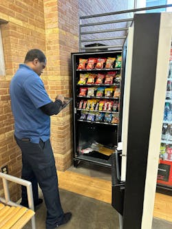 Delivery driver Tyrone restocks a vending machine on one of Executive Refreshments&rsquo; seven routes.