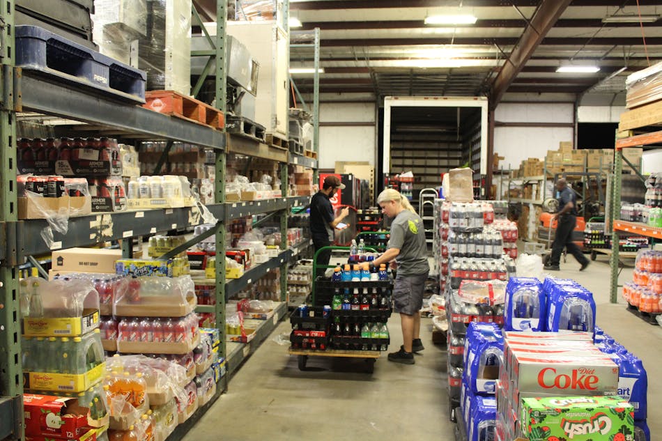 Jenny Satterwhite picking orders in the warehouse.