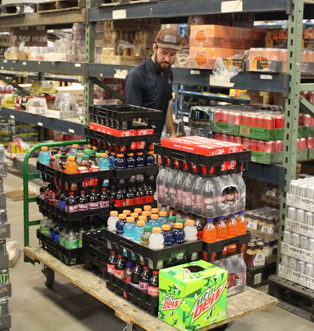 Michael Gearheart picking drinks in the warehouse.