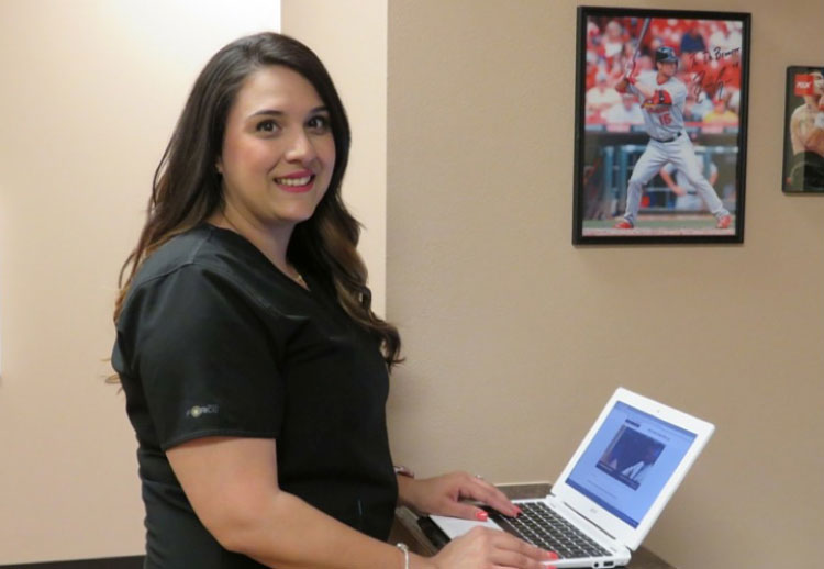 Rickie, Dr. Bennett’s X-Ray Technician, helps patients leave feedback using a Chromebook in the patient checkout area.