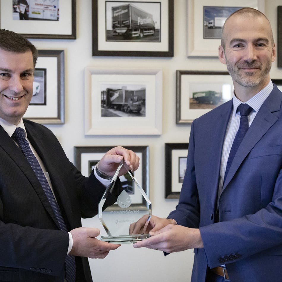 Waterlogic official presents Oceansaver award to Olly Craughan, DPD&apos;s head of corporate social responsibility.